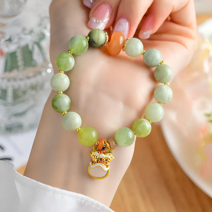 Green milk-in-water Xingshi jade pendant bracelet with geometric retro design on wrist