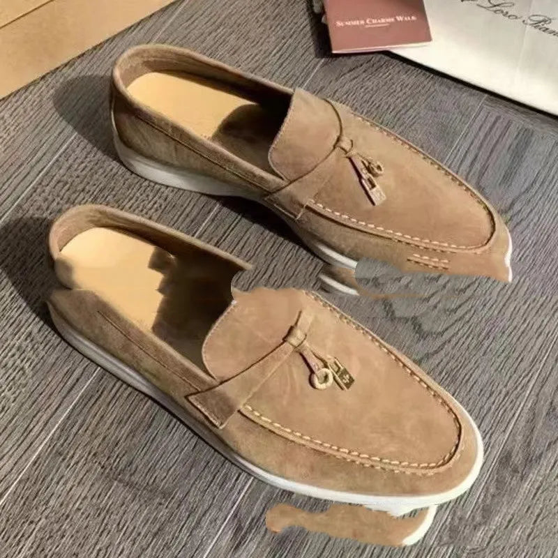 High top slip-on loafers in black with round toe and sewing line detail on a rubber sole.