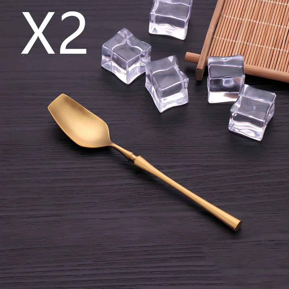 Four-piece stainless steel cutlery set showing main knife, fork, spoon, and teaspoon with mirror finish