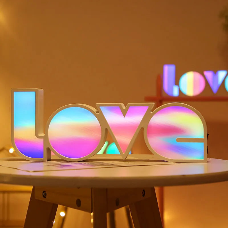 Rainbow halo LED love light with 'LOVE' word decoration on plastic casing.