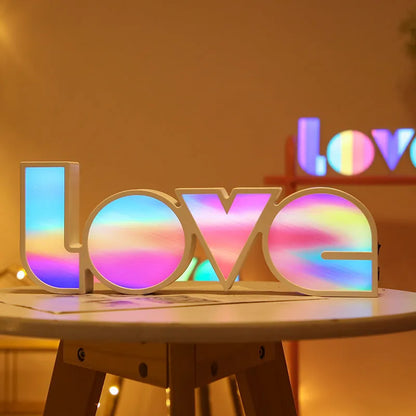 Rainbow halo LED love light with 'LOVE' word decoration on plastic casing.