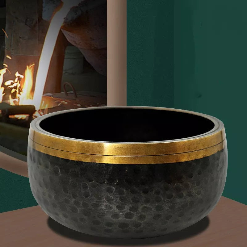 Black and gold copper meditation sound bowl with leather rod and thin pad