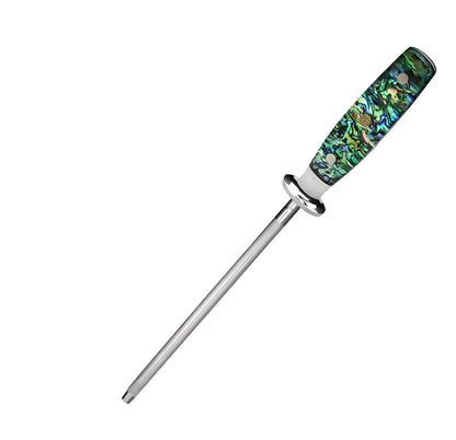 Household knife sharpener with high carbon steel blade and abalone shell handle on a kitchen counter.