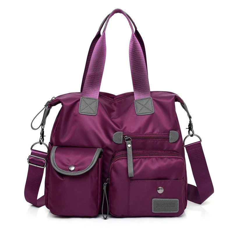 Versatile ladies handbag in various colors with multiple carry options, including handbag, shoulder bag, and crossbody styles, featuring durable construction and organizational pockets.