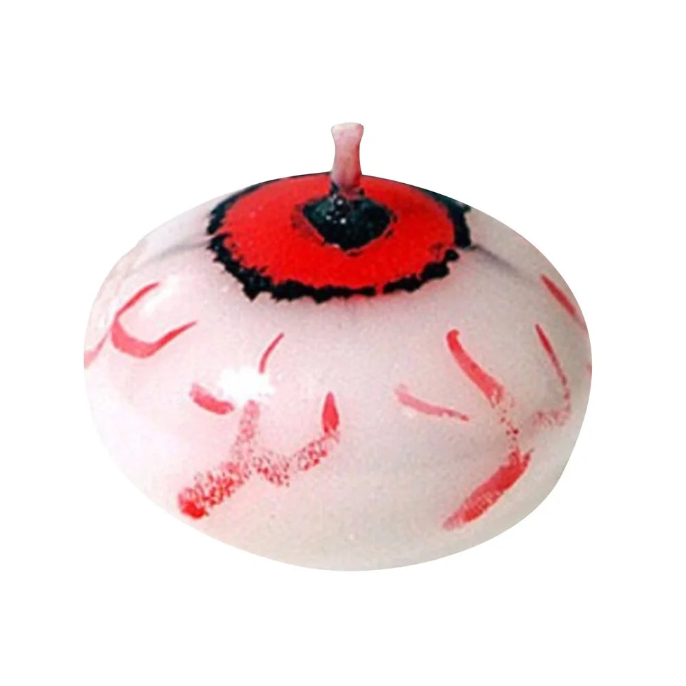 Red oval paraffin floating candle resembling eyeball in Halloween water display