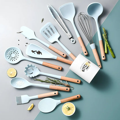 Blue silicone non-stick cookware set with frying spatula, colander, egg beater, and white iron storage bucket for kitchen organisation