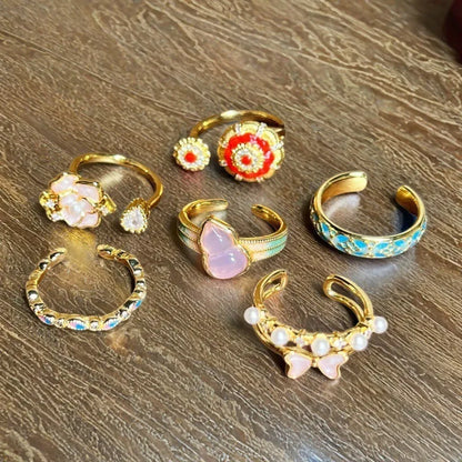Adjustable copper gourd ring with zircon stones showing flower and bow design elements