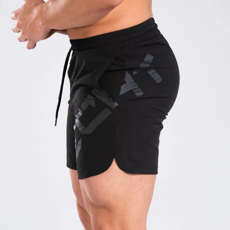 Men's black quick-dry training shorts with elastic waistband, shown knee-length.