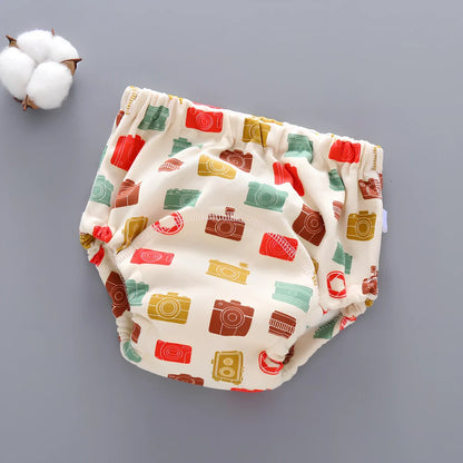 Washable baby training pants with 6-layer gauze construction in assorted patterns including animals and geometric designs