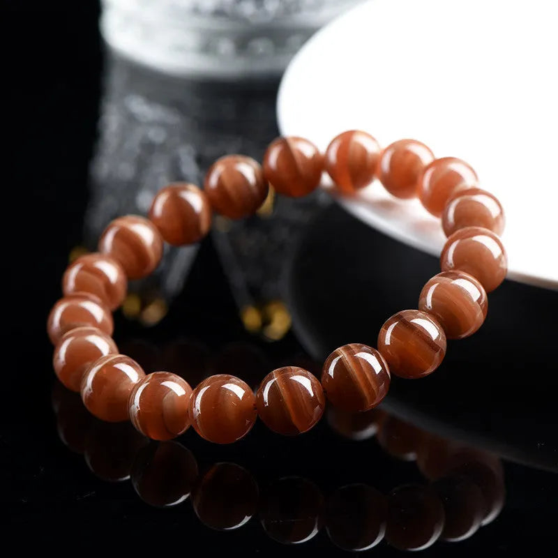 Natural old mine rhodochrosite bracelet with round geometric beads showing manganese spar colour variations