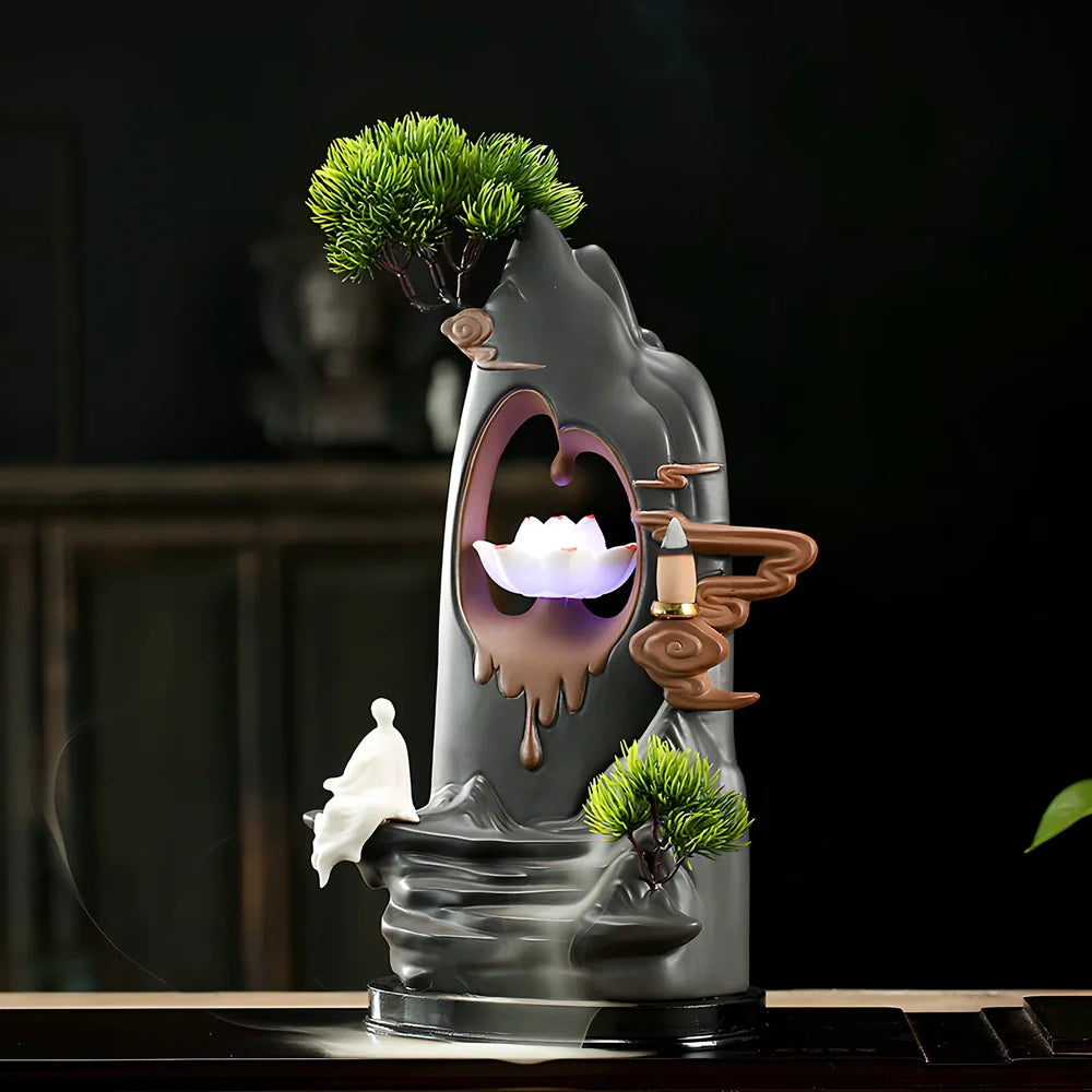 Purple sand tea pet backflow fragrance ornament with LED lighting creating cascading smoke effect