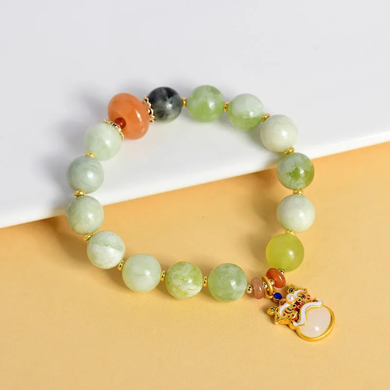 Green milk-in-water Xingshi jade pendant bracelet with geometric retro design on wrist