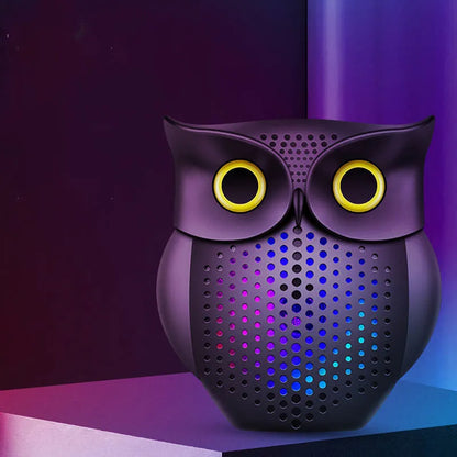 Black cartoon owl design wireless Bluetooth speaker on a surface.