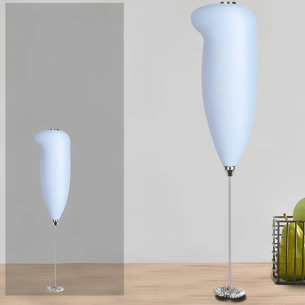 Green electric milk frother measuring 21cm tall with 5cm base creating milk foam