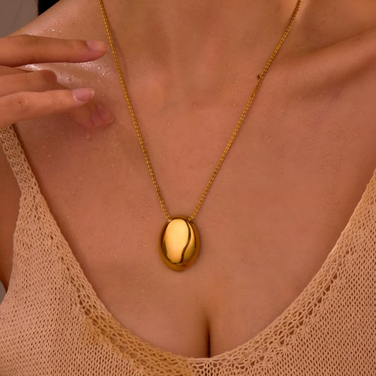 Gold-toned geometric pendant necklace on a chain, showing adjustable length between 41 cm and 50 cm.