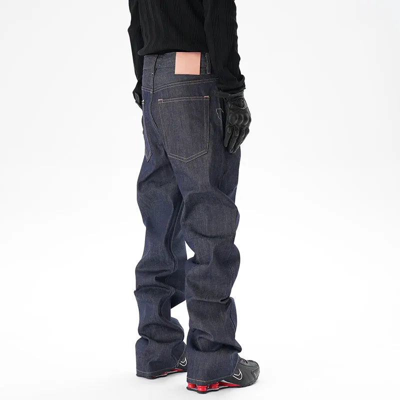 Man wearing dark blue loose-fit straight-leg denim jeans, showcasing the casual relaxed silhouette.