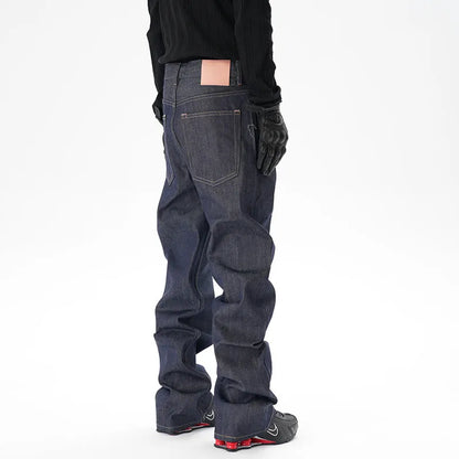 Man wearing dark blue loose-fit straight-leg denim jeans, showcasing the casual relaxed silhouette.