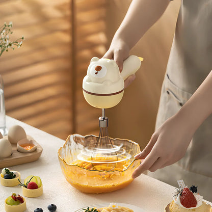 Yellow handheld electric whisk with stainless steel beaters and USB power cable