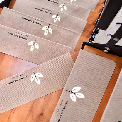 Self-adhesive luminous stair mat with glow strips on wooden staircase, rectangular design with hemmed edges