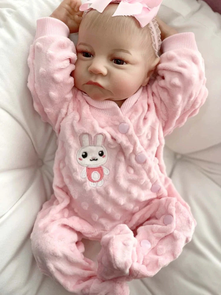 18-inch reborn doll with cloth body and hand-painted vinyl head wearing pink romper