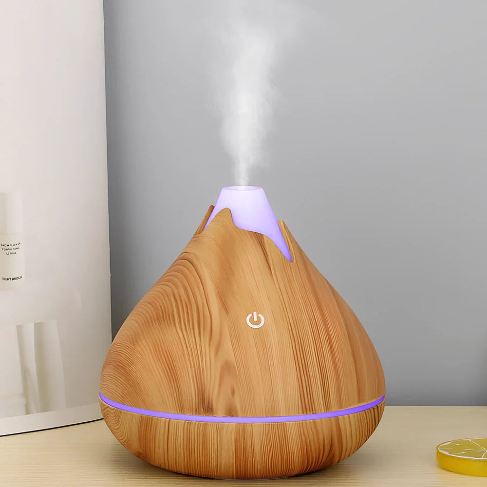 Round wood grain humidifier with USB cable and single mist outlet on light oak finish
