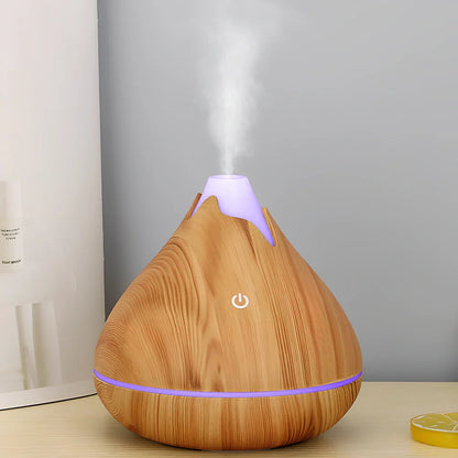 Round wood grain humidifier with USB cable and single mist outlet on light oak finish