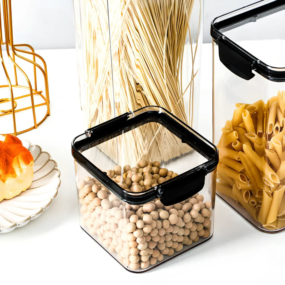 Eight transparent airtight plastic food containers in four different sizes with red sealing lids