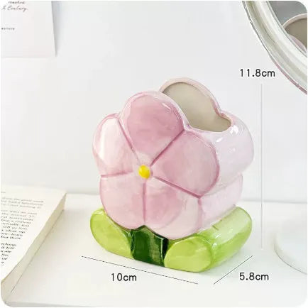 Ceramic floral pen holder showing blue flowers pattern, measuring 11.8cm wide by 10cm high