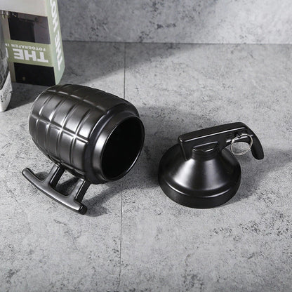 A white or black ceramic coffee mug with a grenade-inspired design and a secure lid for on-the-go convenience.