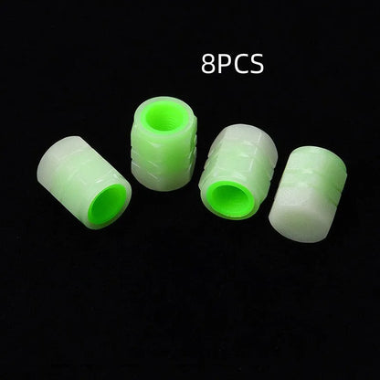 Set of four luminous rubber valve caps for car tyres showing glow effect