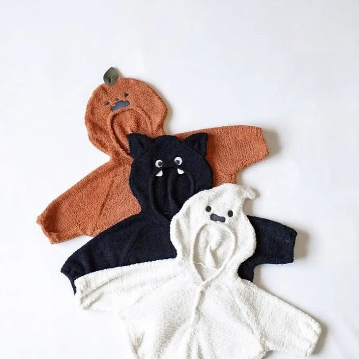 Baby wearing festival-themed plush top with hood and long sleeves in fleece fabric