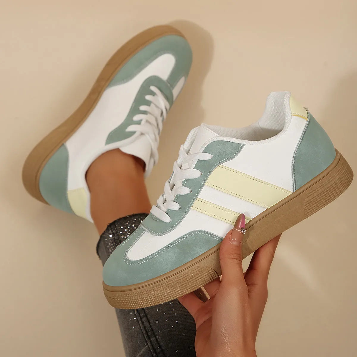 Green women's low-top retro sports shoes with cross-strap design and round toe.