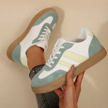 Green women's low-top retro sports shoes with cross-strap design and round toe.