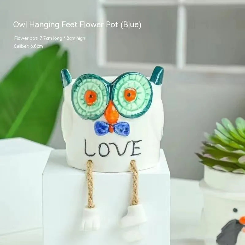 Ceramic hanging foot flowerpot for succulent plants with cartoon styling on desktop