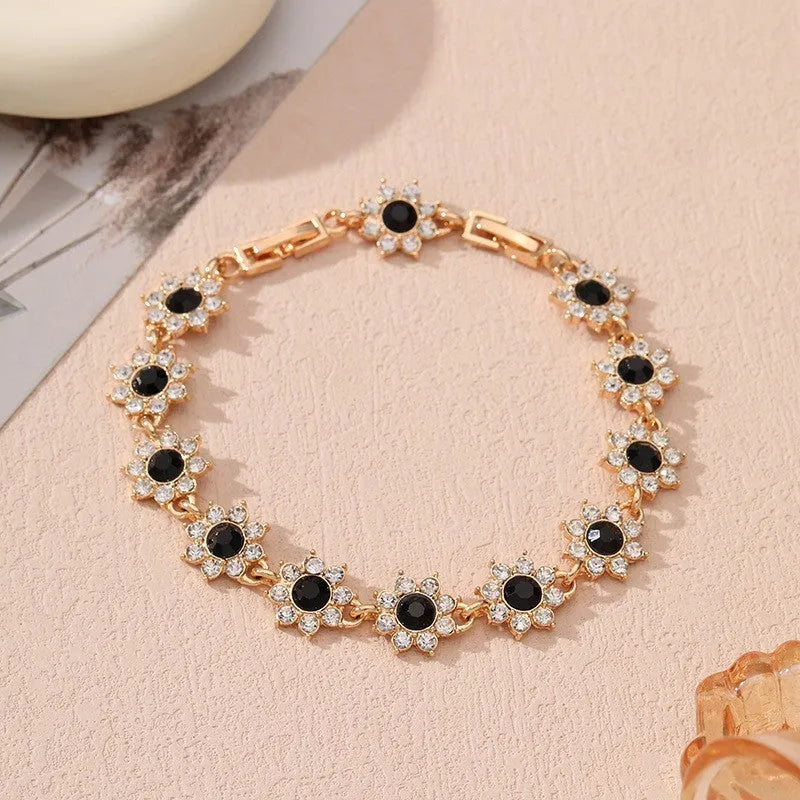 Floral shaped zinc alloy bracelet with electroplated colourful gem finishes in gold and silver tones.
