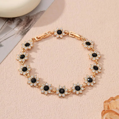Floral shaped zinc alloy bracelet with electroplated colourful gem finishes in gold and silver tones.