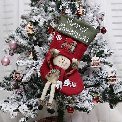 Set of three large red, white, and brown Christmas stockings with 3D Santa, Snowman, and Reindeer designs hanging on a tree.