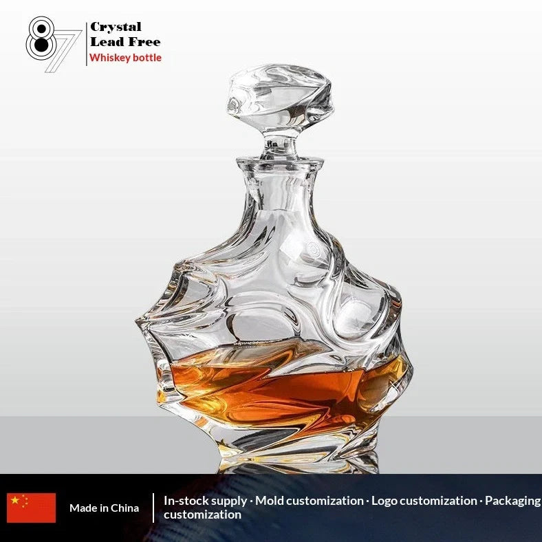 Hand-cut Bohemian crystal whiskey decanter with retro design and tapered pouring neck on wooden bar