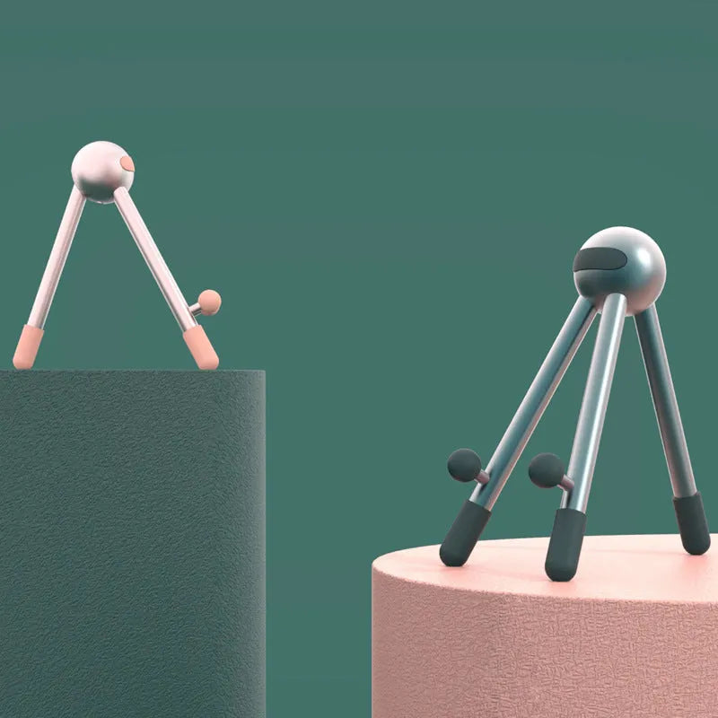 Aluminium alloy desktop phone and tablet stand with 120-degree adjustable angle, alien shape, green and pink options.