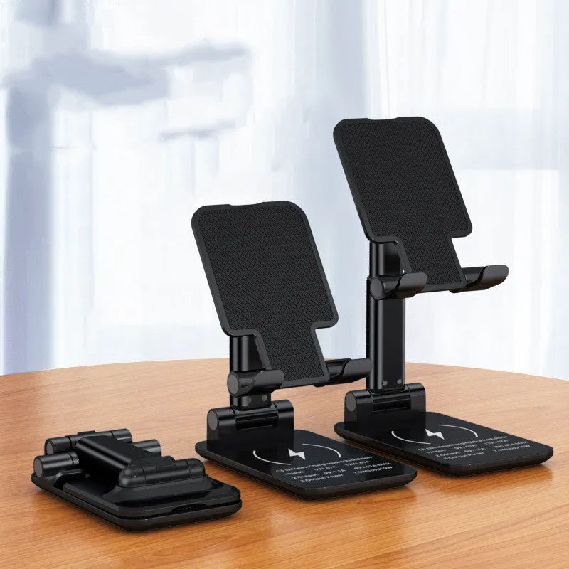 Black desktop wireless charging stand holding mobile phone at angle with power cord connected