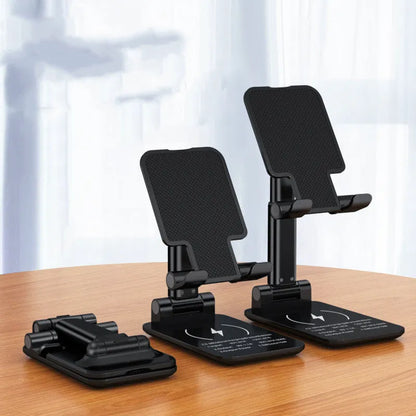 Black desktop wireless charging stand holding mobile phone at angle with power cord connected