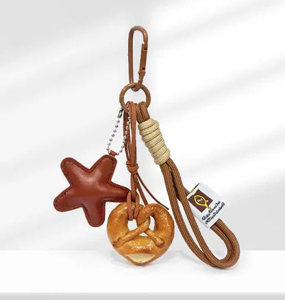Handmade soda bread handbag pendant with cartoon croissant design on 30cm brown adjustable strap
