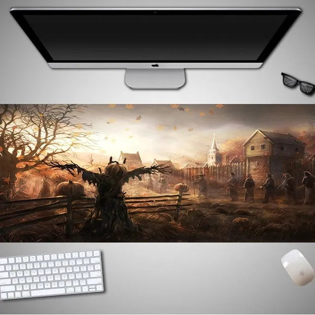 Halloween-themed oversized cloth mouse pad with non-slip rubber base on a wooden desk.