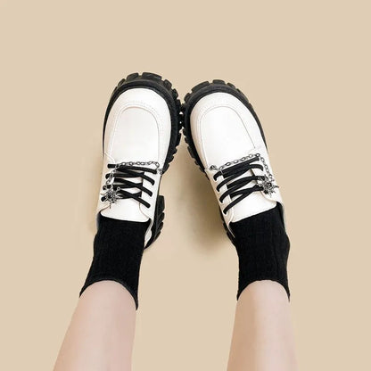 Women's Duke Asterism preppy loafers with a round toe and metal cross shoulder strap.
