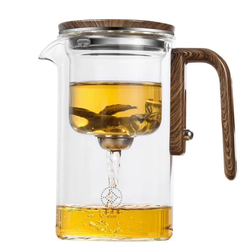 Elegant glass tea infuser pot with magnetic separation technology, wooden handle, and precise pouring spout