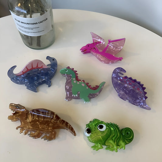 Acrylic dinosaur jaw clip hairpin showing six colour variations: pink, green, purple, blue, brown