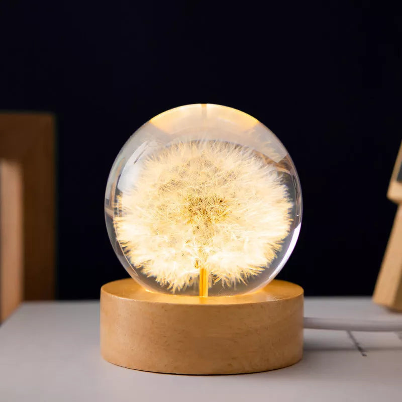 LED Dandelion Crystal Ball Night Light with oak base emitting soft glow
