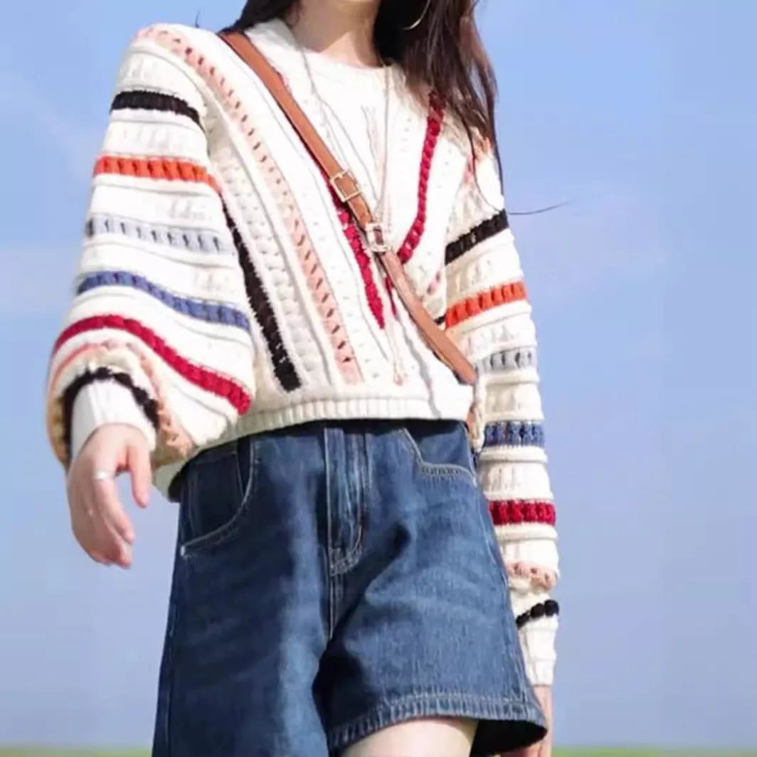 Rainbow striped batwing sleeve hollow knit sweater with round neck, shown in loose fit on model