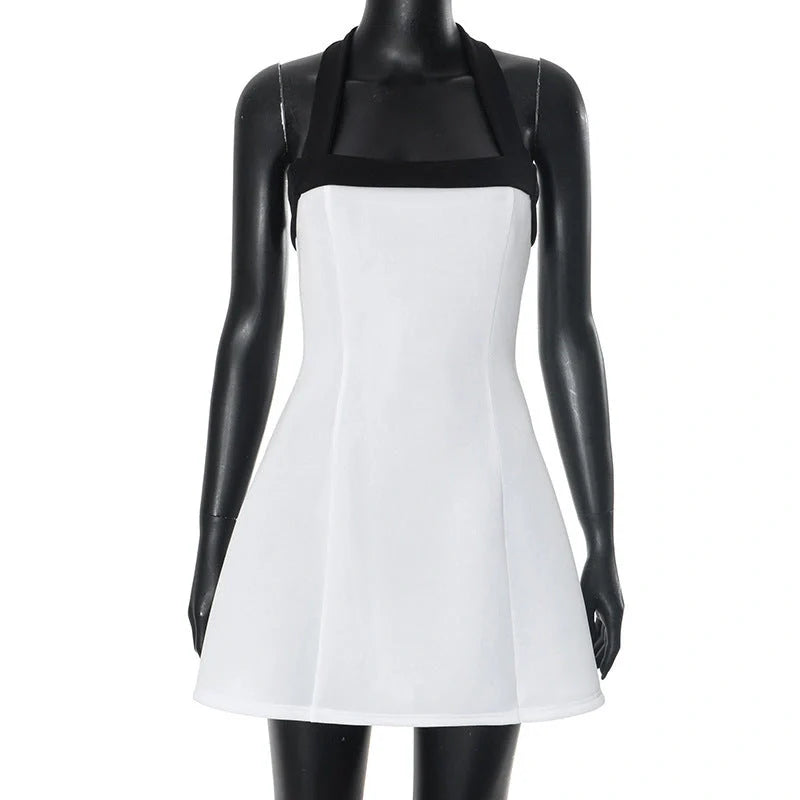 Chic off-shoulder mini dress with halter neckline, sleeveless design, and contrasting white and black colors