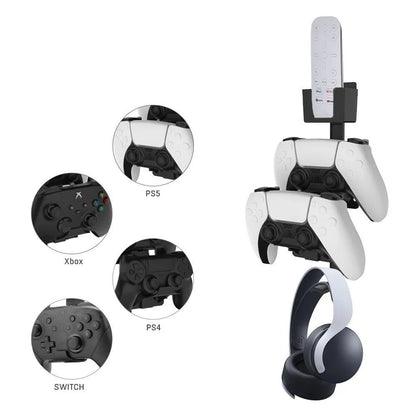 A white wall-mounted plastic hook holding a black game controller and a TV remote.